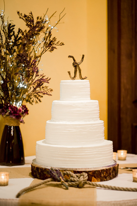 classic white cake with wicker monogram topper