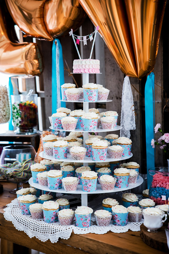 cupcake tower topped by mini cake