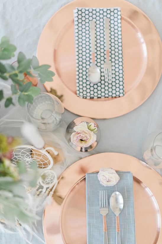 copper place setting with patterned napkins