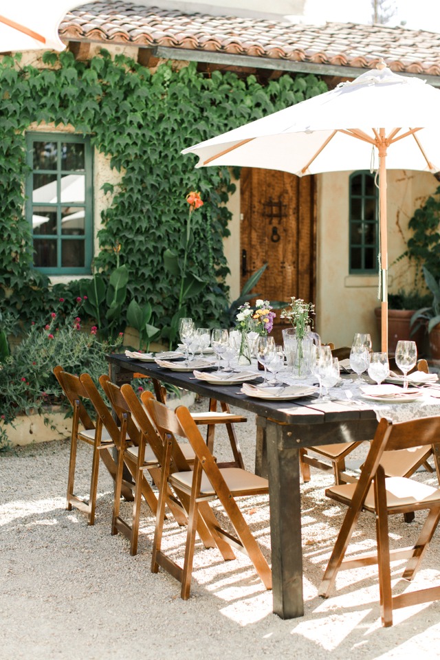 garden courtyard wedding dinning under umbrellas