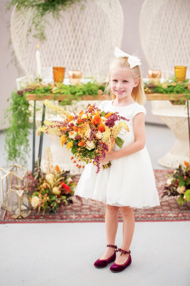 sweet little flower in burgundy flats with a fall bouquet