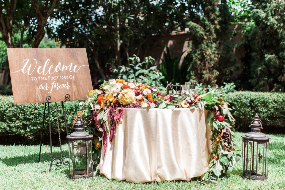 gold sweetheart table with cascading floral decor