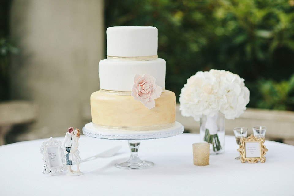 Gold and white cake with pink flower