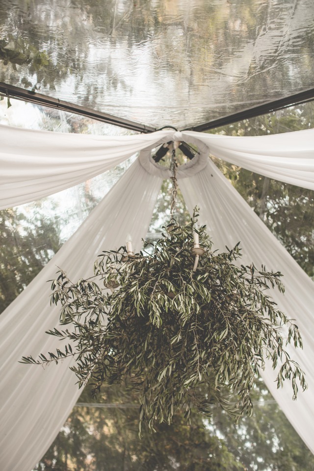 hanging greenery chandelier under reception tent