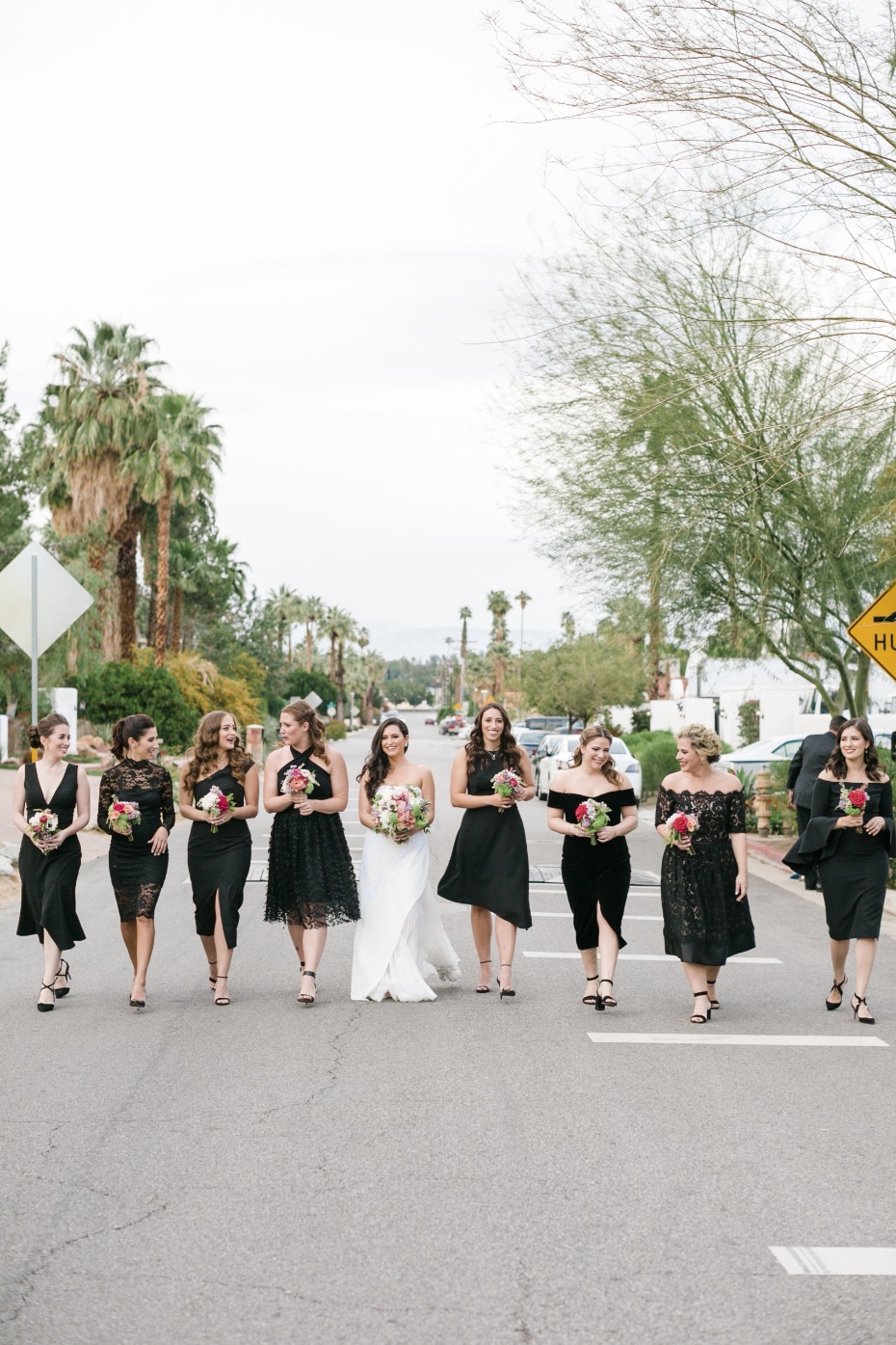 Bridesmaids in mismatched black dresses