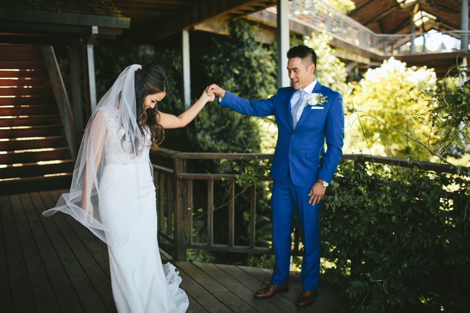 groom in royal blue admiring his bride