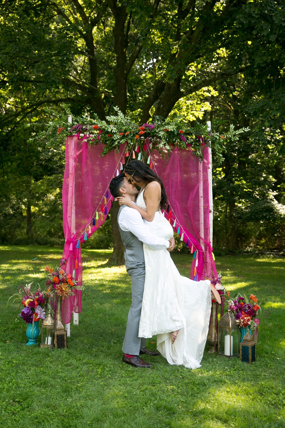 happy bride and groom with whimsical boho moroccan style backdrop