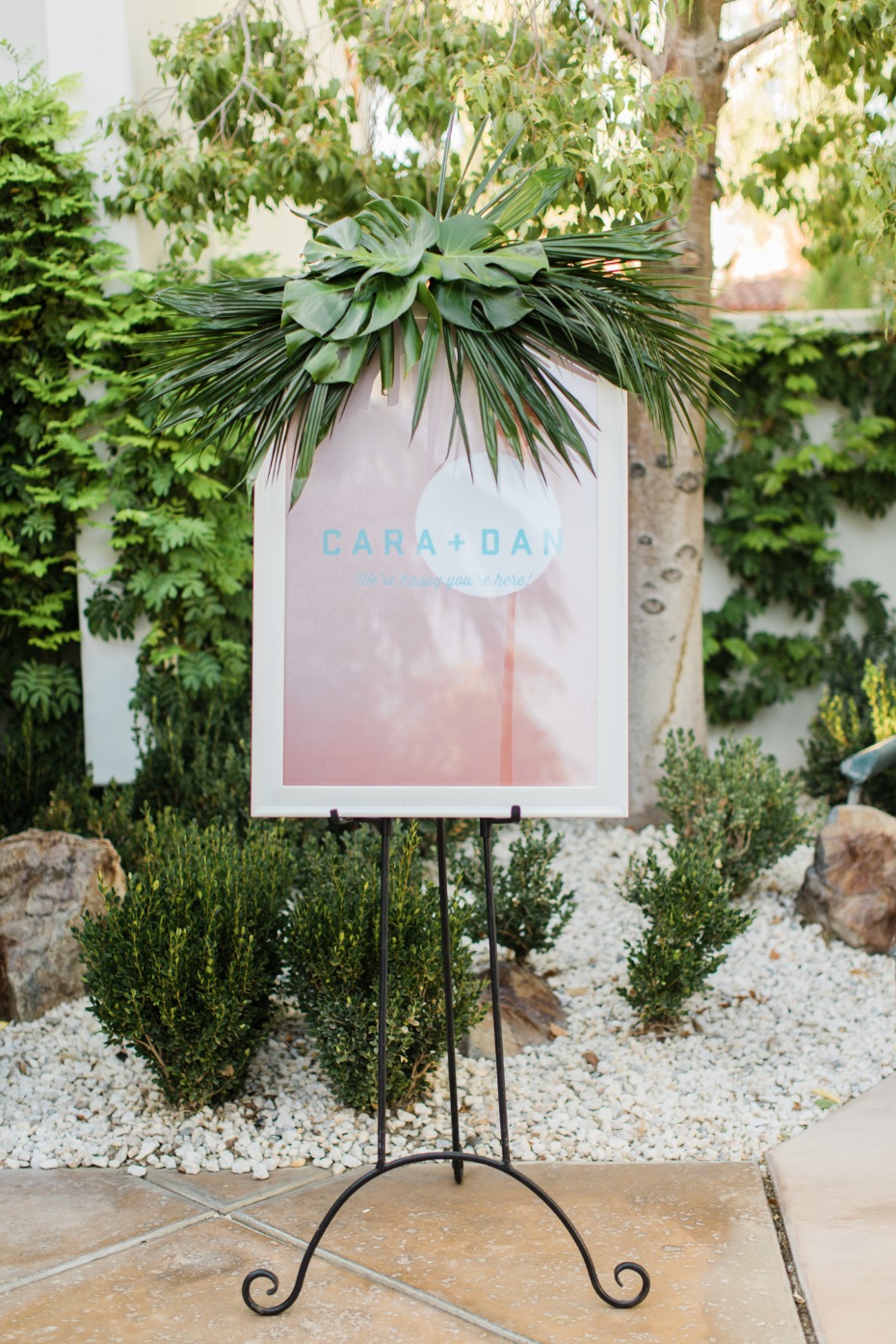 Custom designed wedding sign with tropical greenery