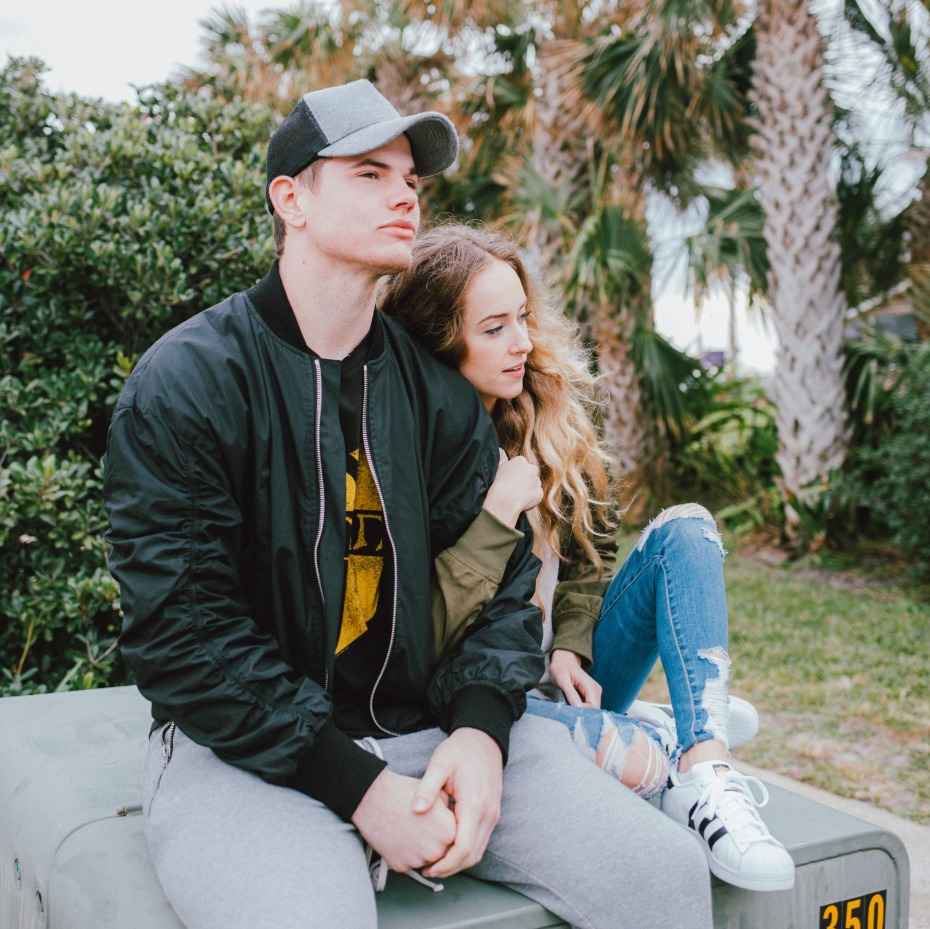 Couple sitting with linked arms