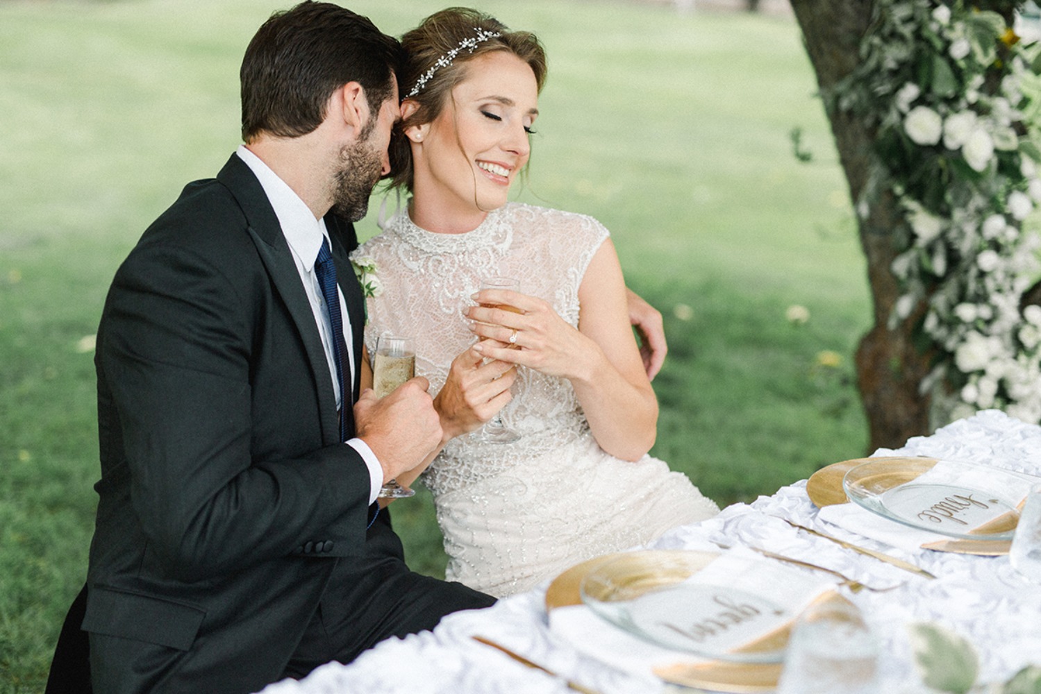 candid wedding couple at their sweetheart table