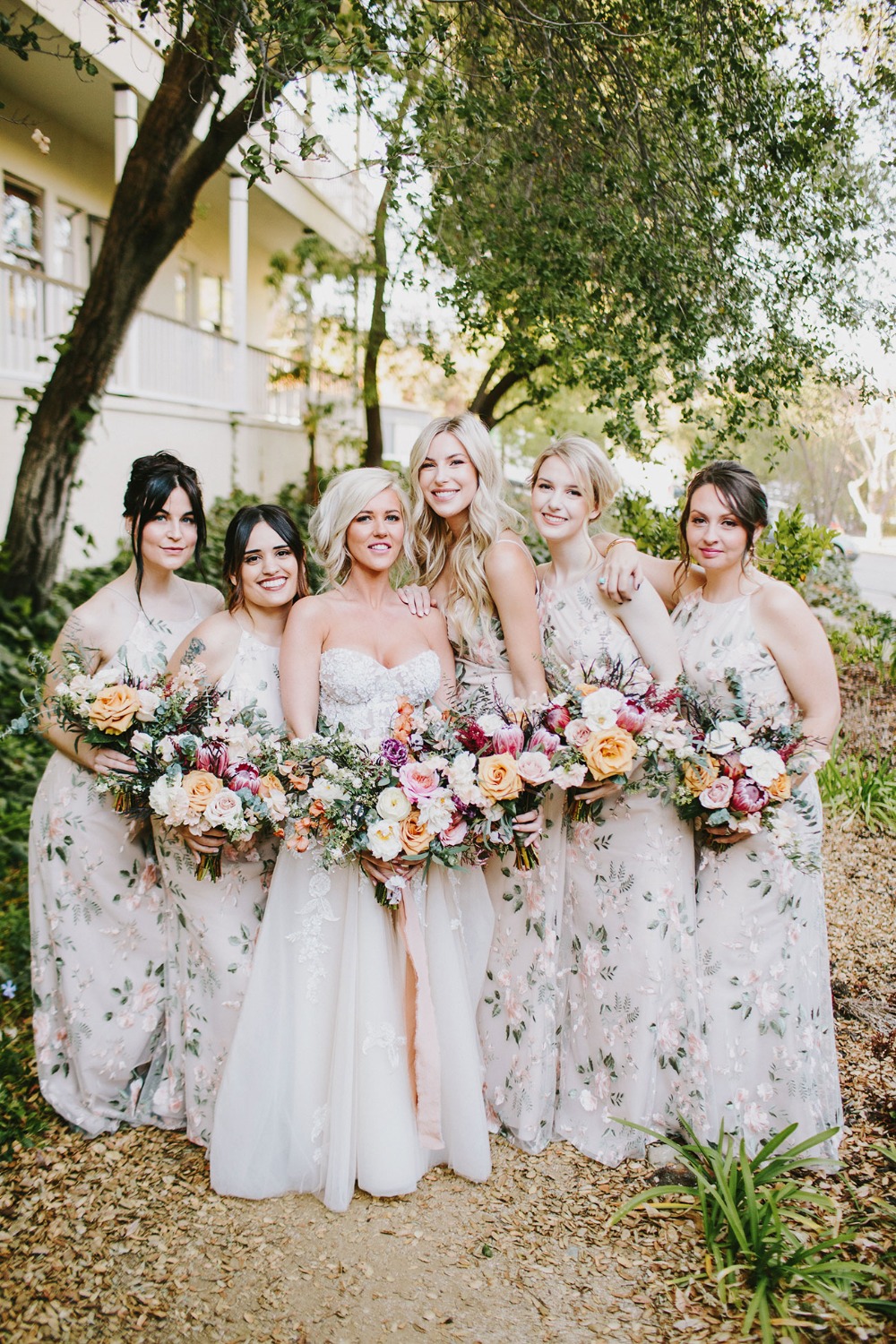 bridesmaids in floral Jenny Yoo dresses