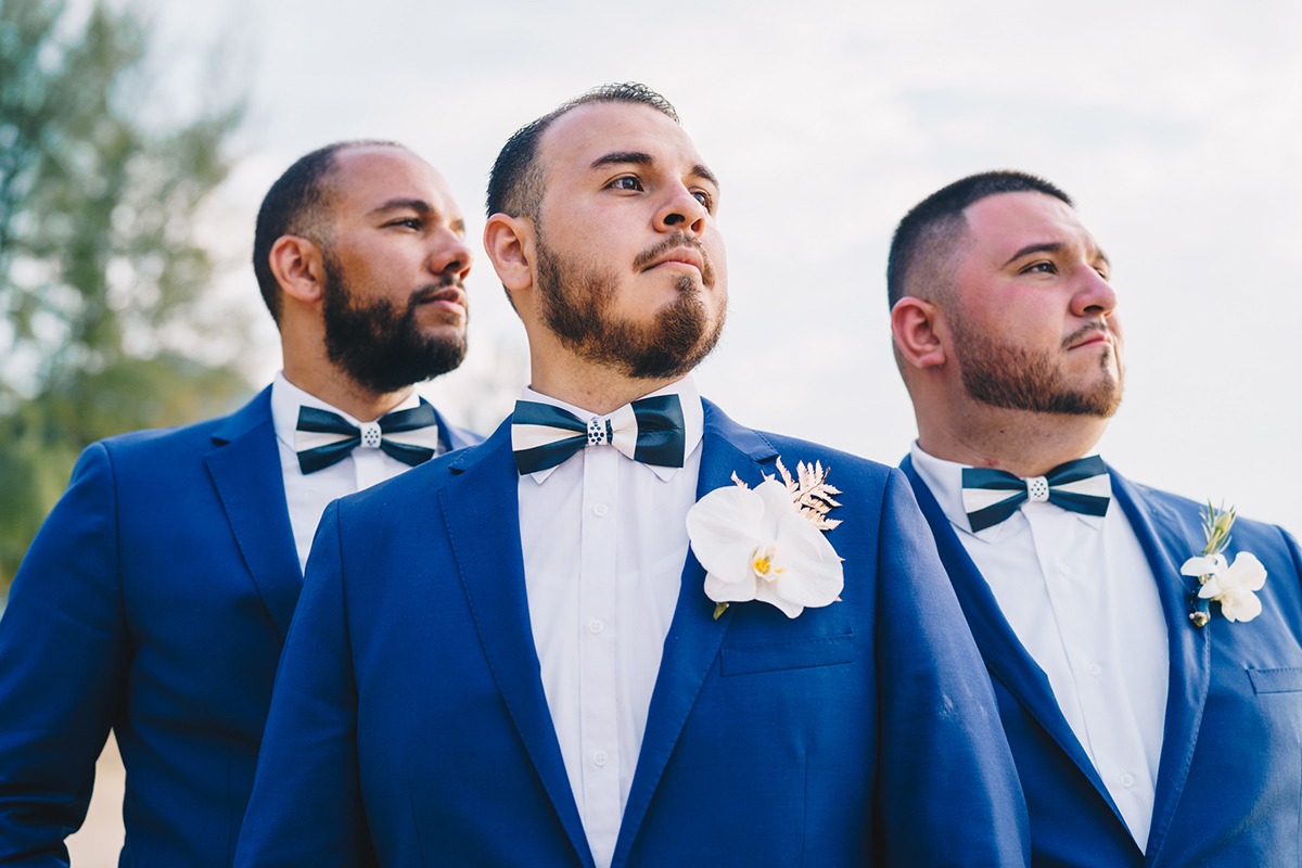 Navy suit with orchid boutonniere