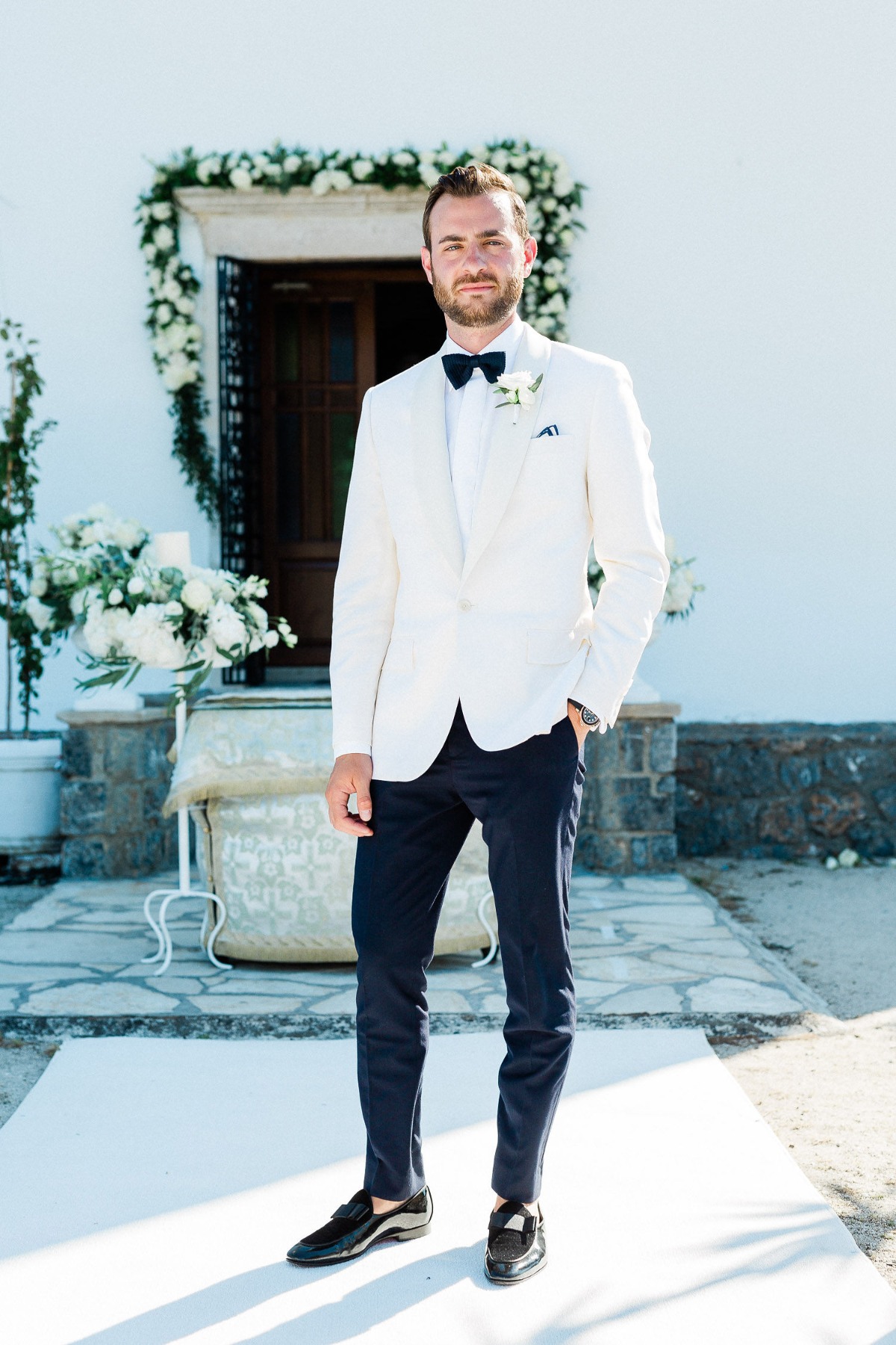 Groom in white and black tux