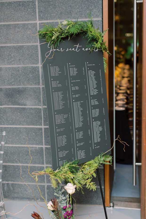 modern wedding seating chart with greenery