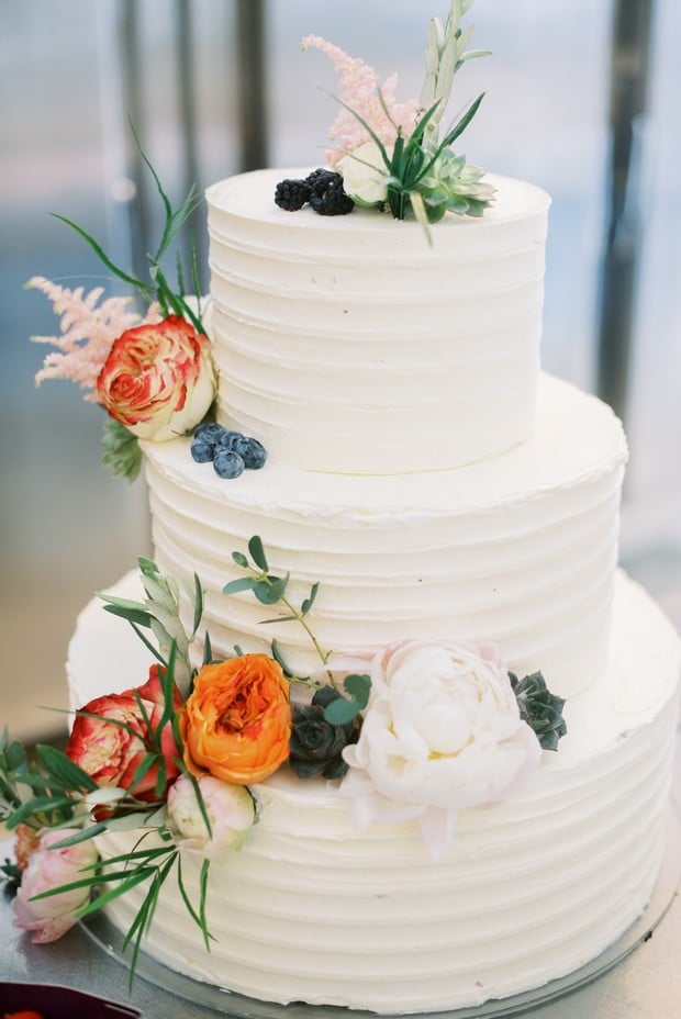white wedding cake adorned with florals