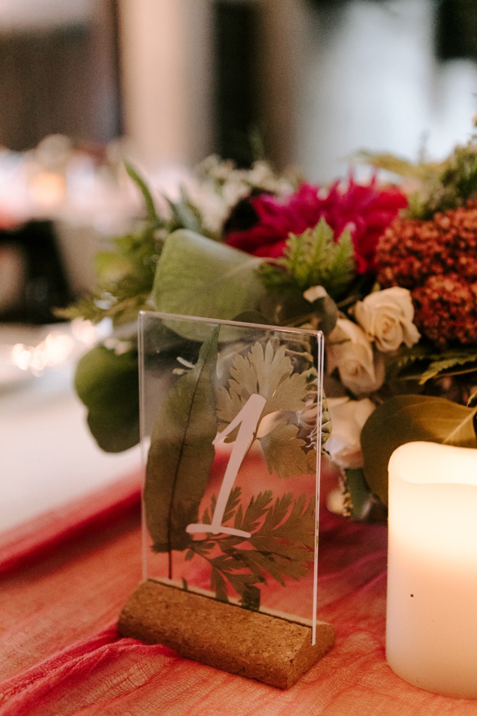 table numbers with plants with greenery in them