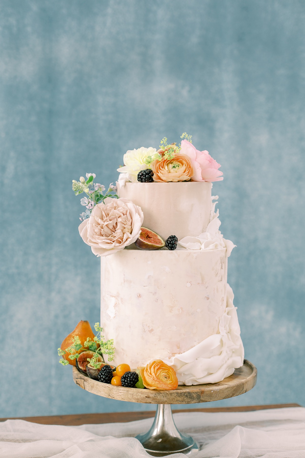 white wedding cake adorned with florals