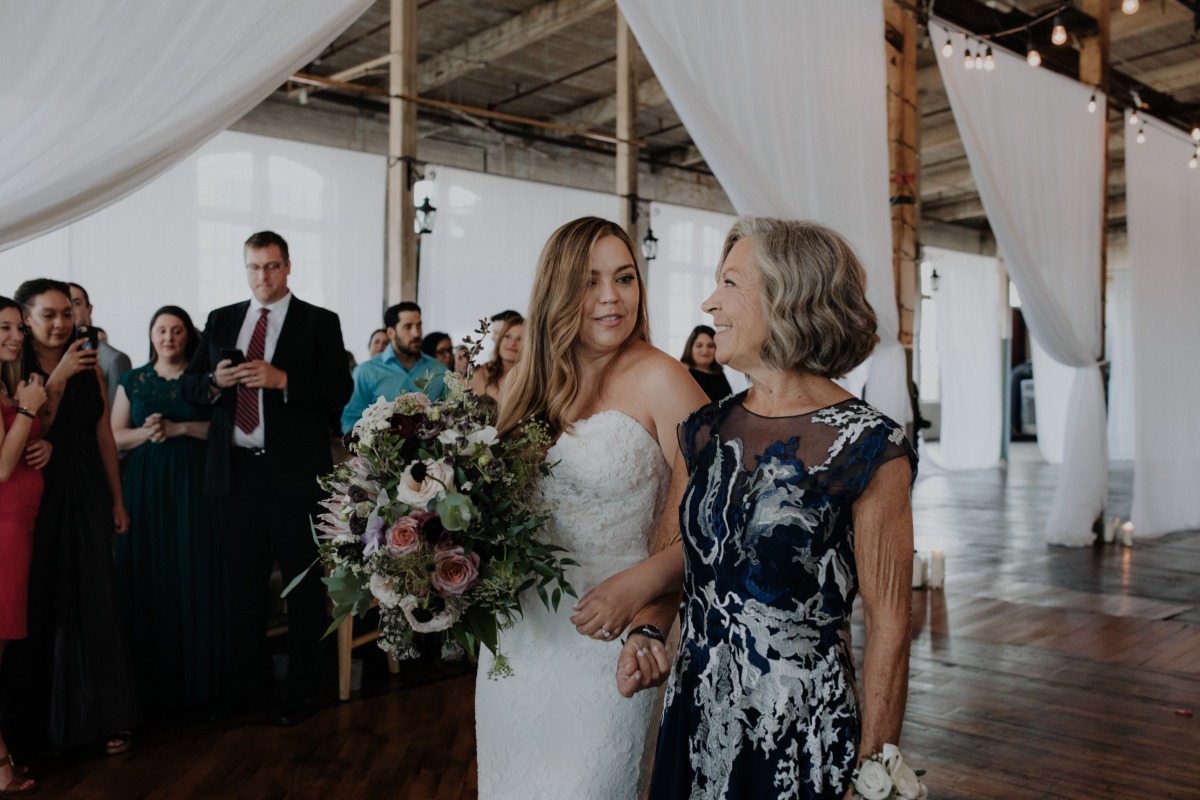 Mom walking daughter down the aisle