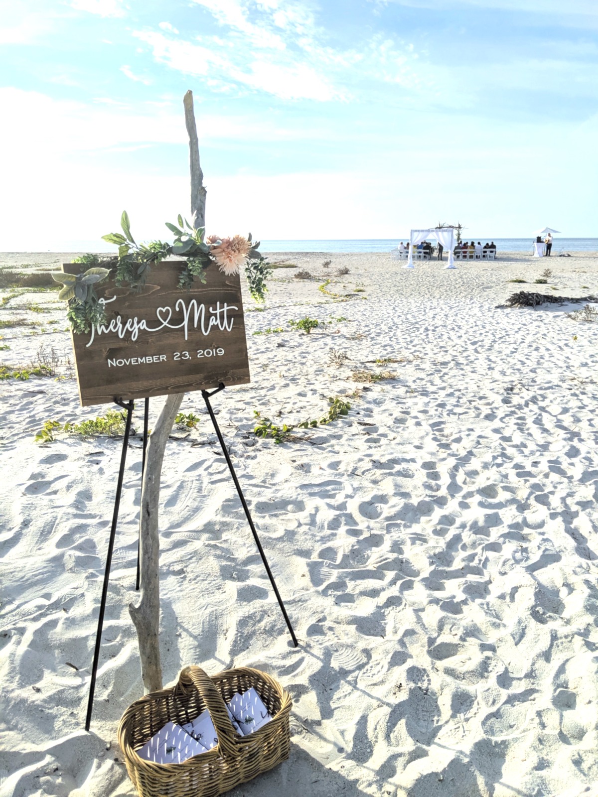 wooden wedding sign adorned with florals