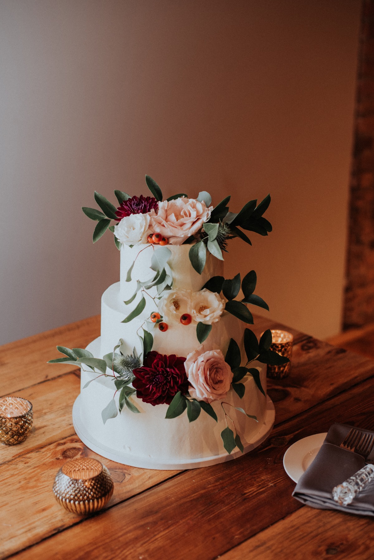 white wedding cake adorned with florals