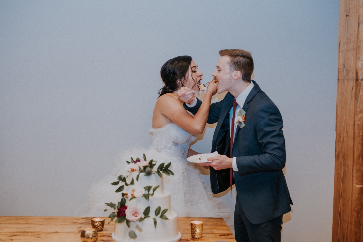 bride and groom cutting the cake