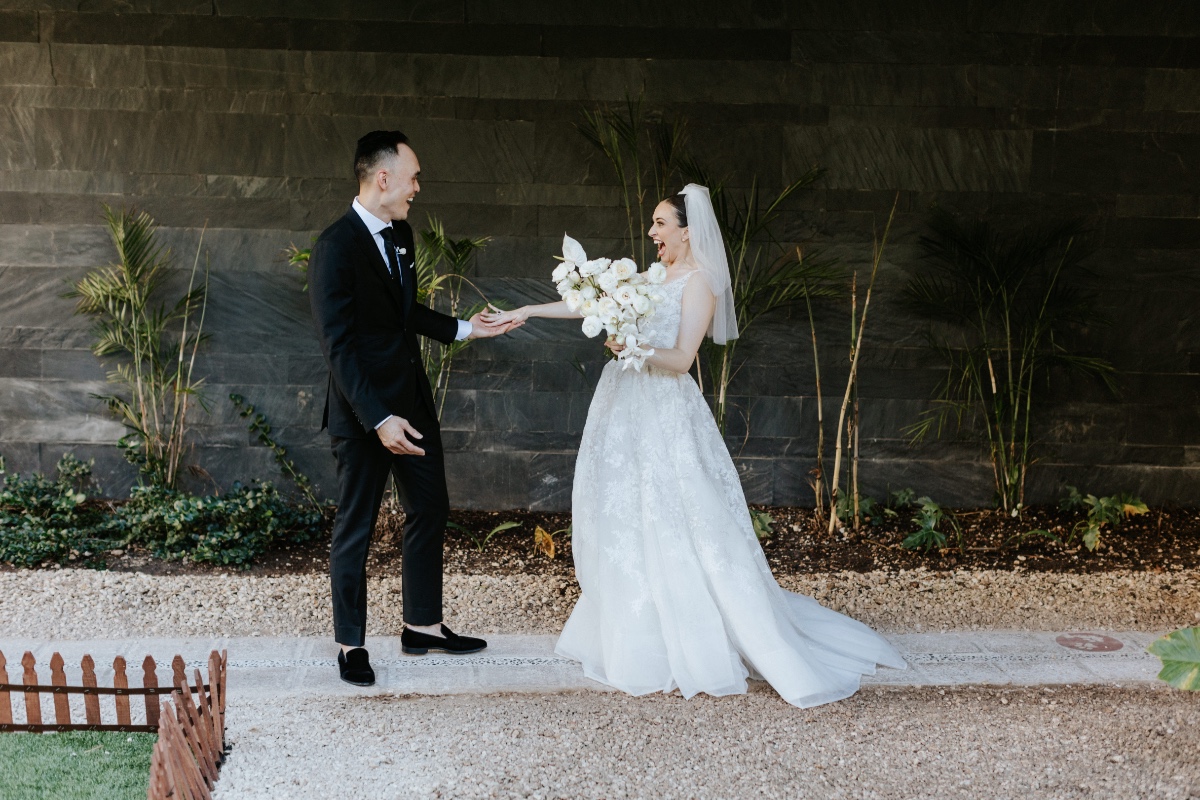 Groom and bride laughing after seeing bride for first look