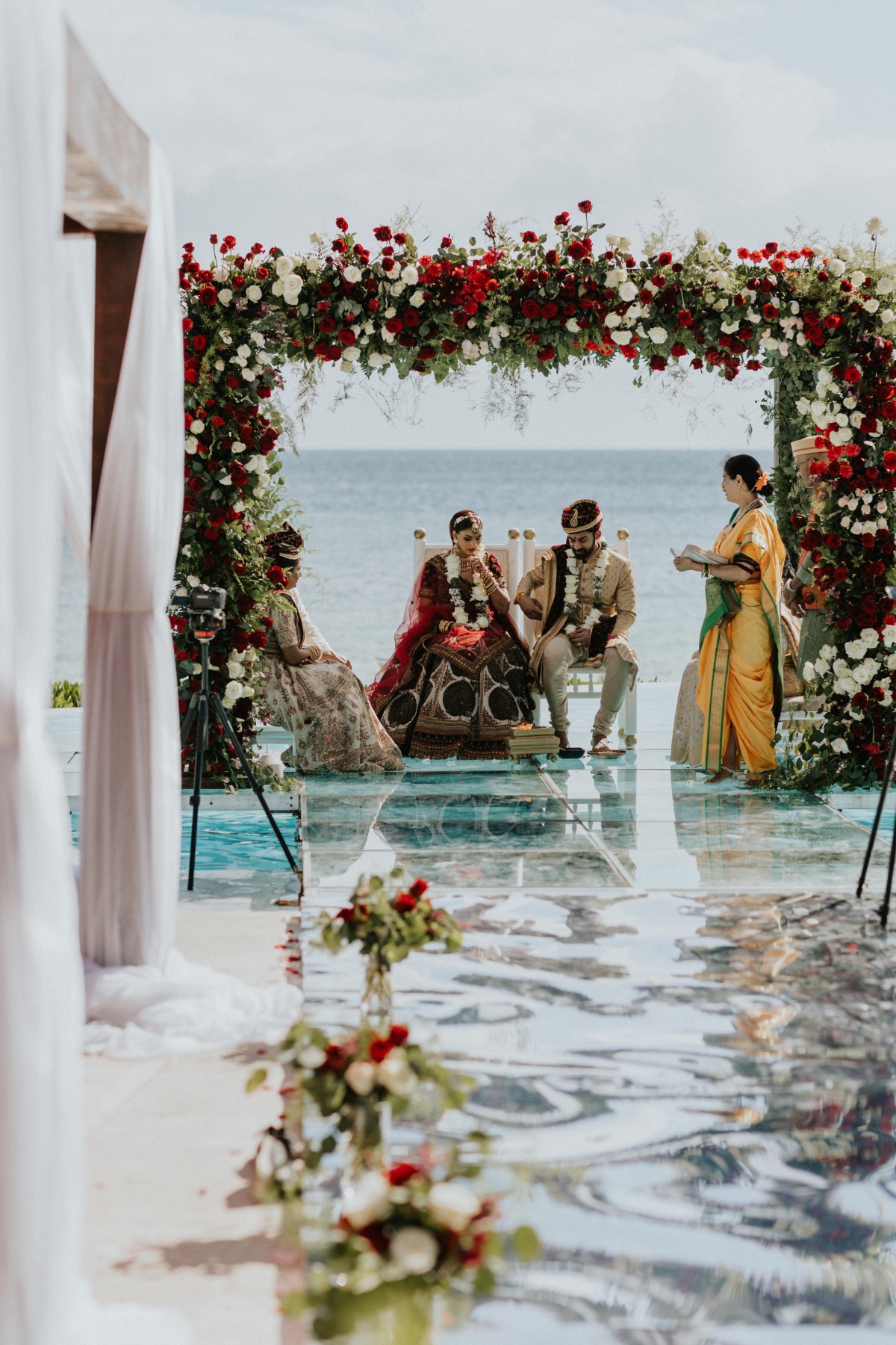 red and white rose floral arch with bride and groom Hindu wedding ceremony