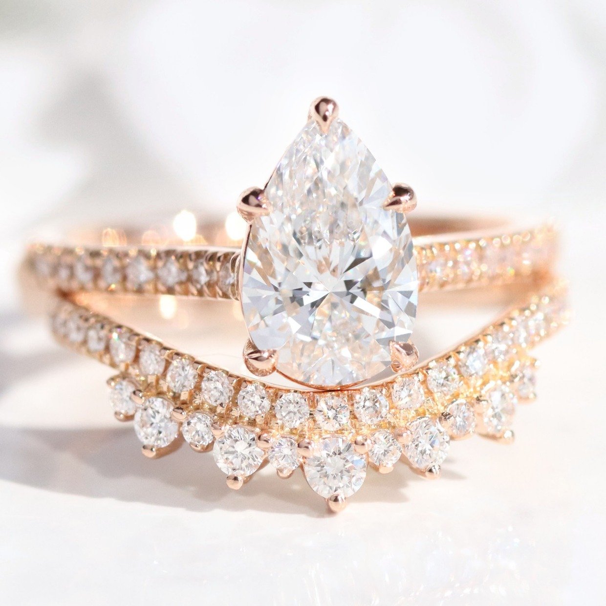pear shaped diamond engagement ring and matching band in rose gold by Lámore Design