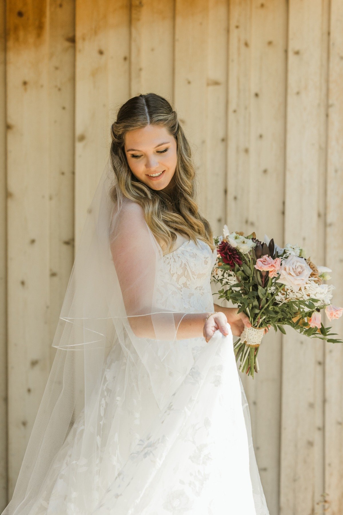 bride in lace at rustic venue