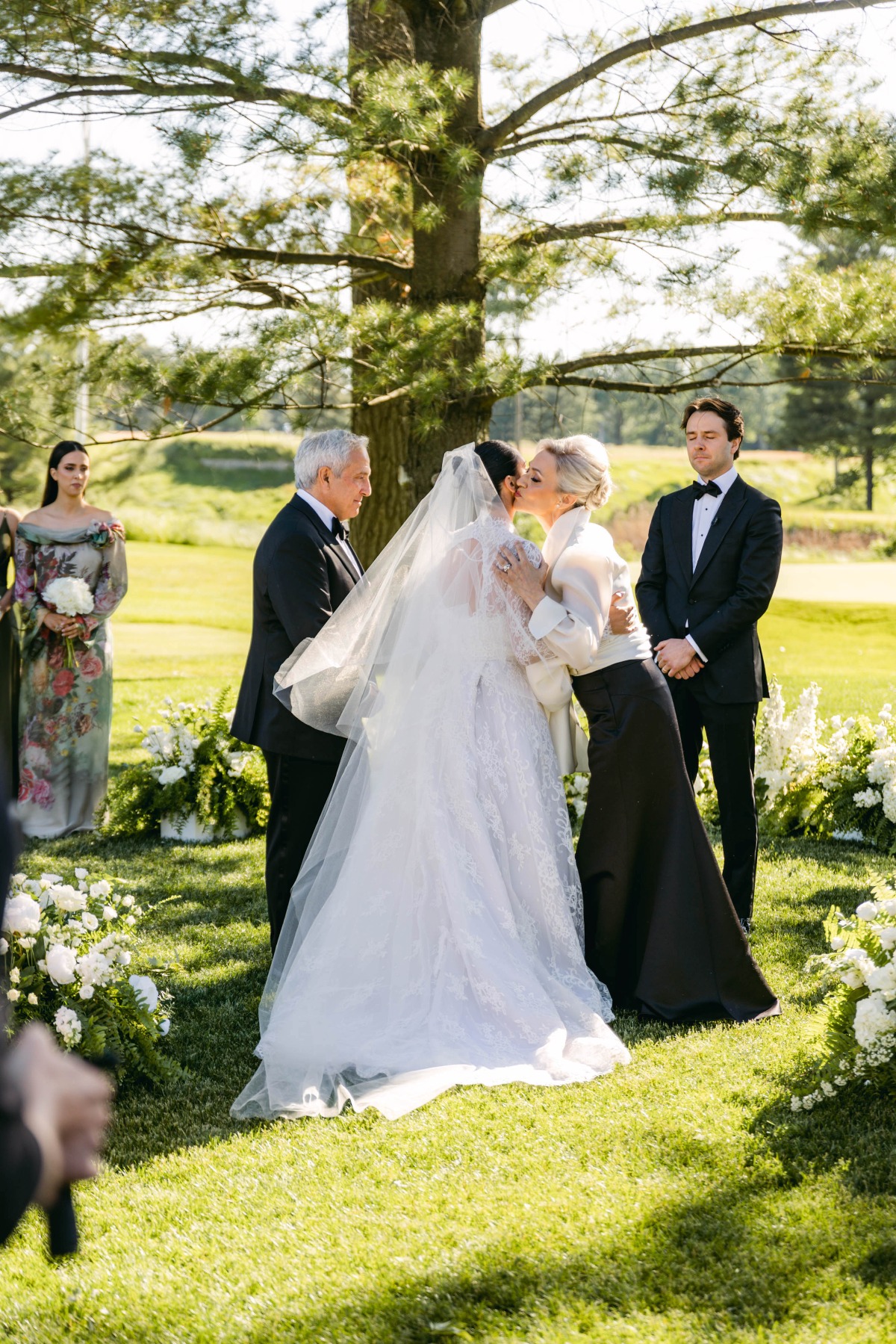 mother of the bride kissing bride 