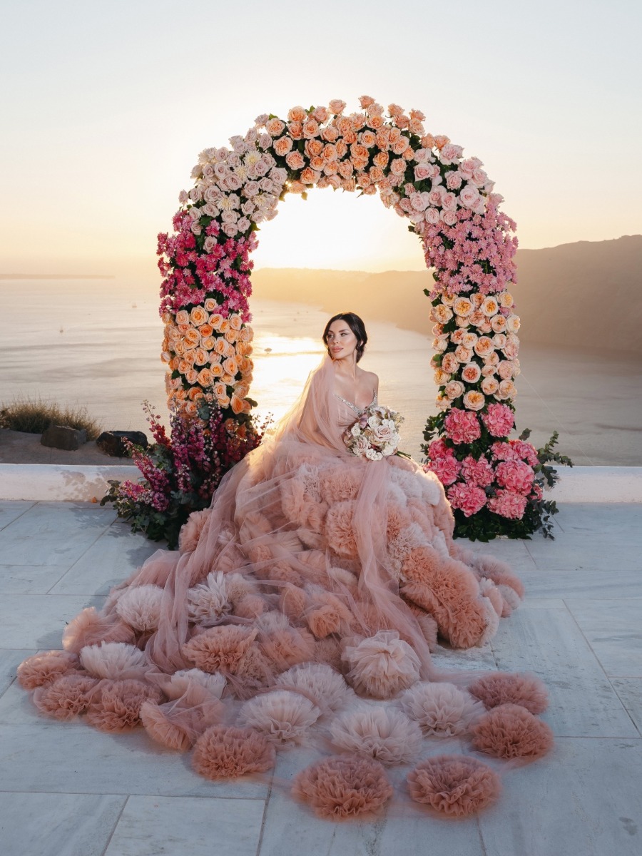 The bride's couture pink gown was a vision of the Santorini sunset 