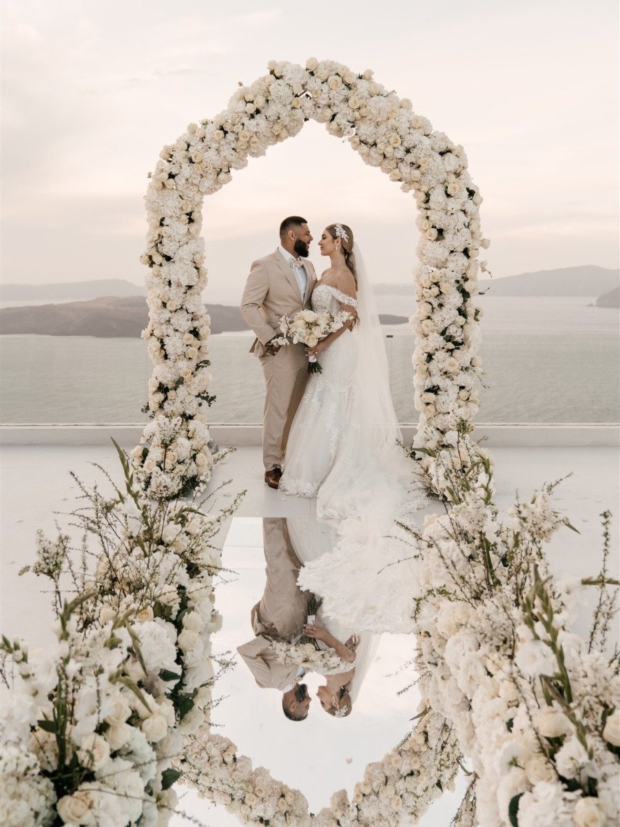 A white sunset micro-wedding with macro luxury details in Santorini