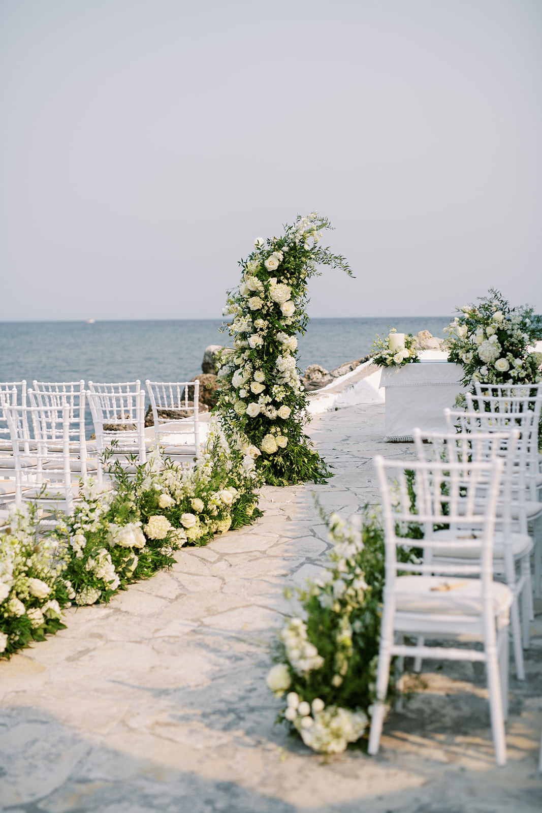 curved white flower and greenery columns