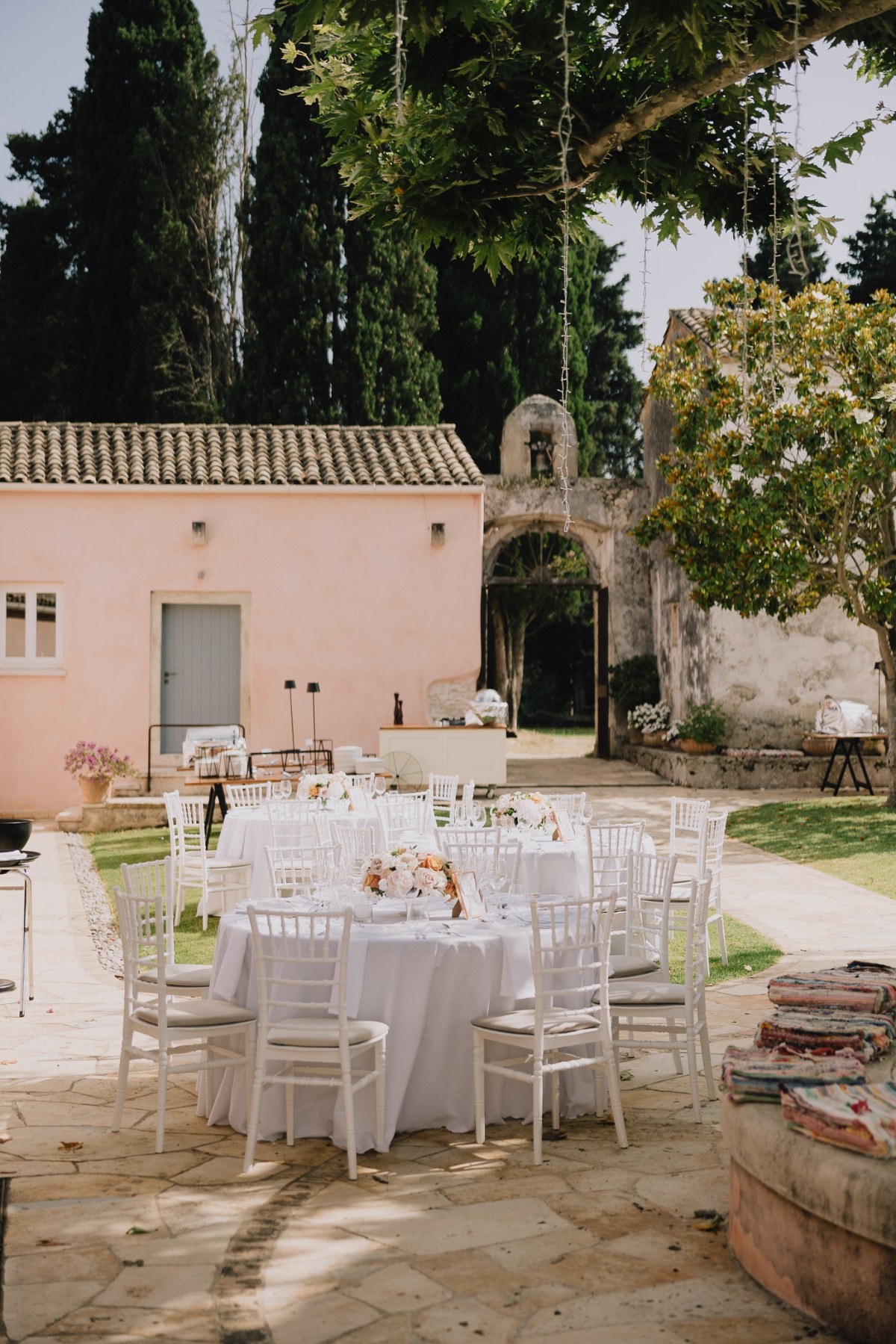 outdoor all white reception with colorful centerpieces