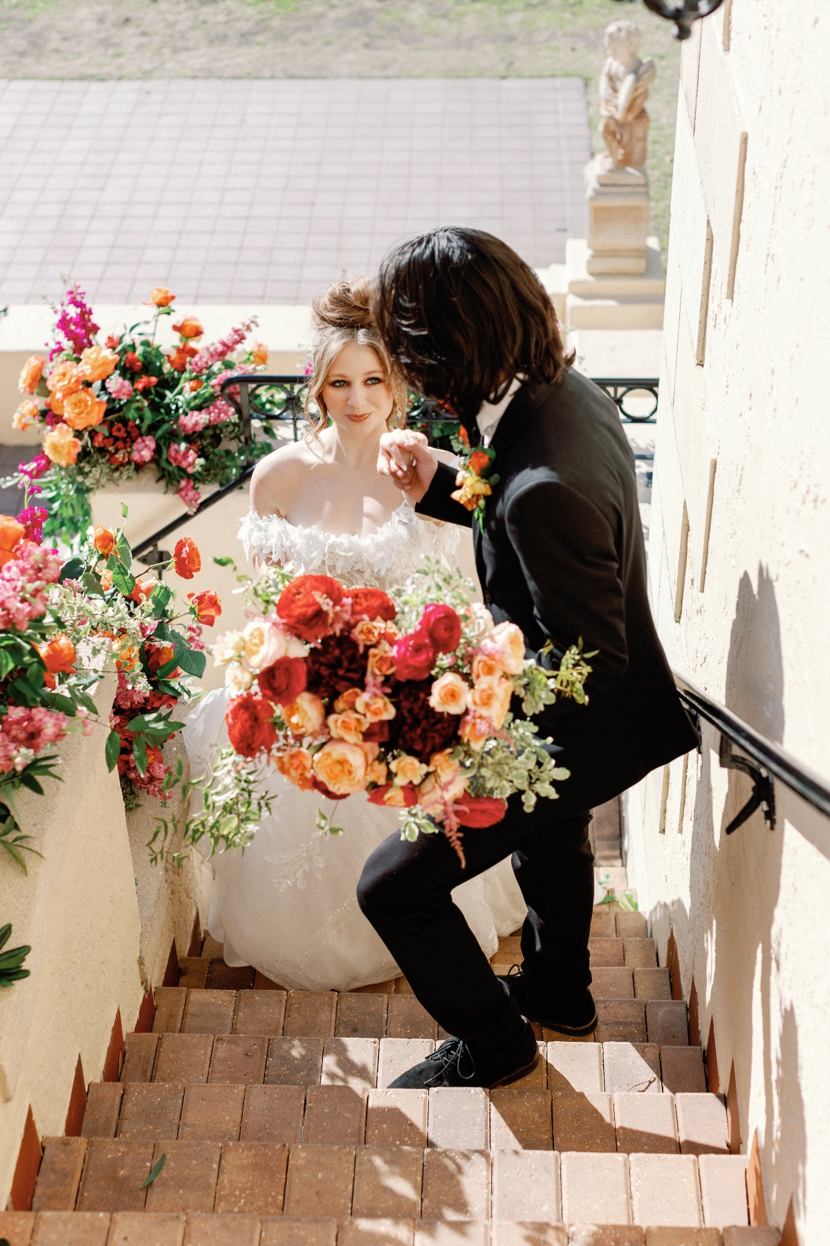 Colorful sunset palette bouquet and wedding flowers on stairs 