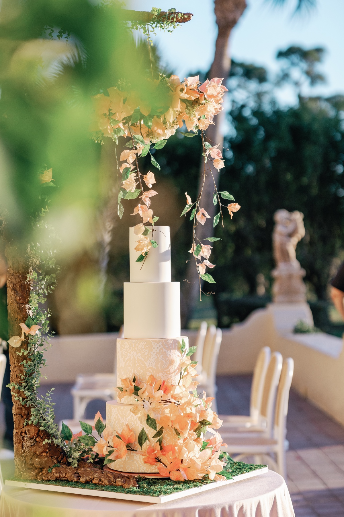 Unique peach floral and viney tree themed wedding cake 