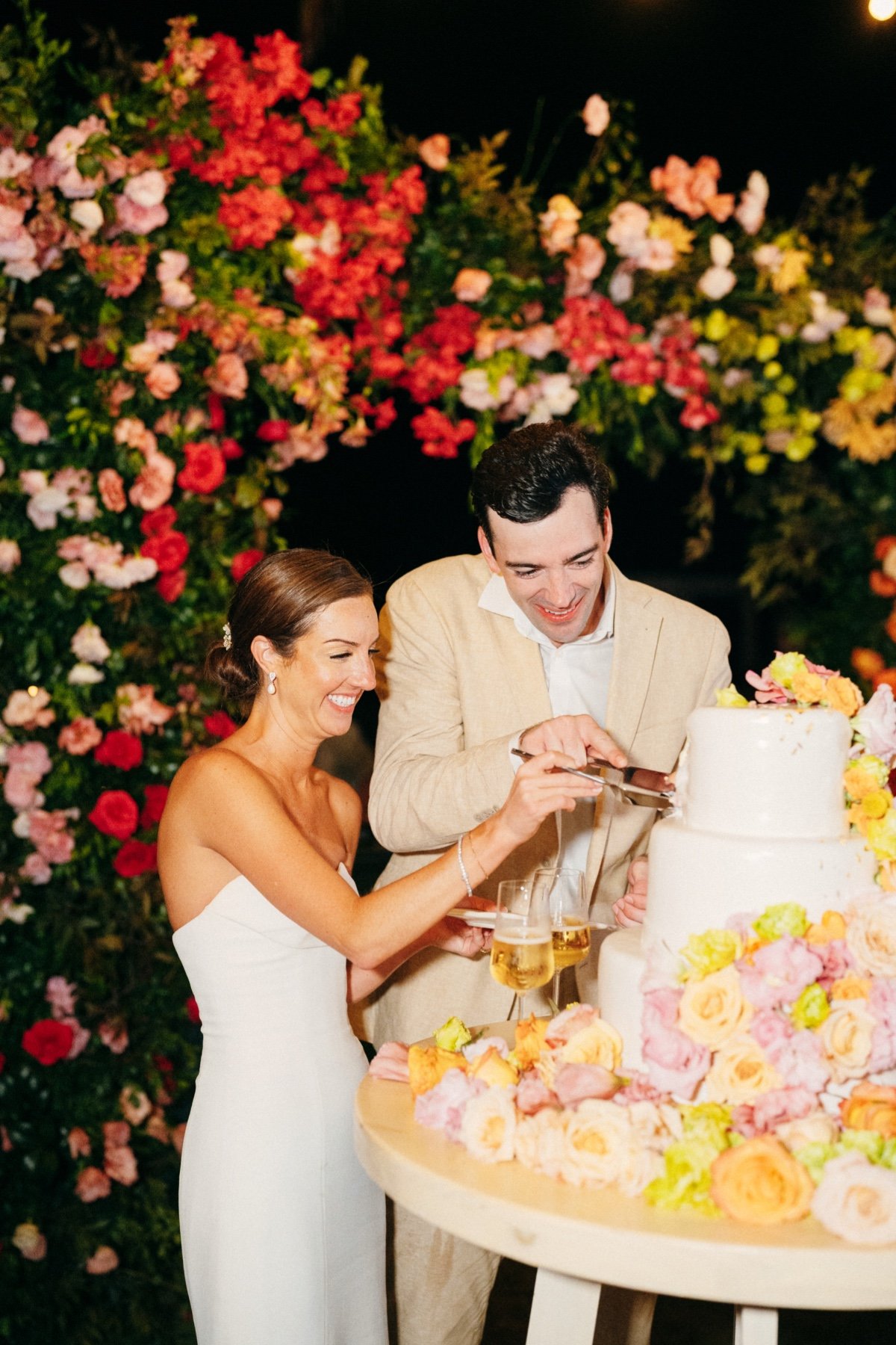 white wedding cake with colorful florals