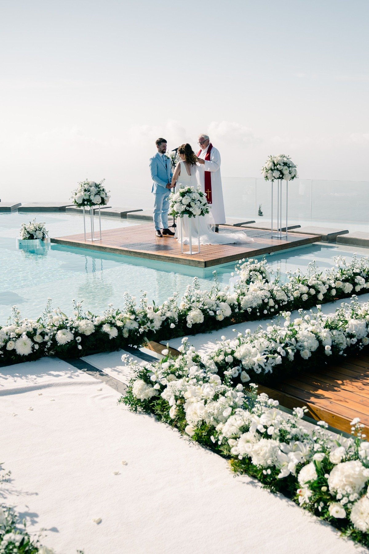Luxurious white flower filled wedding ceremony in Greece