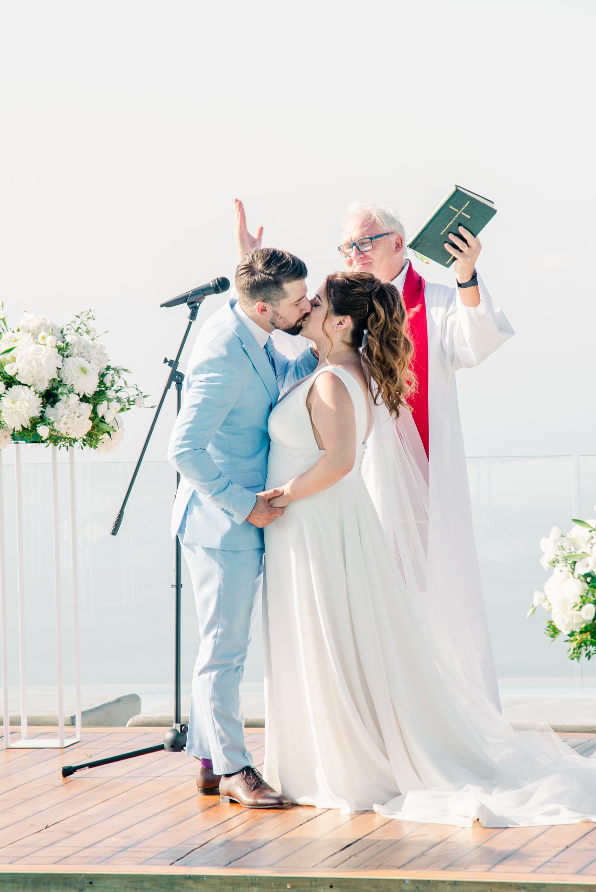 First kiss at modern Greek island wedding ceremony 