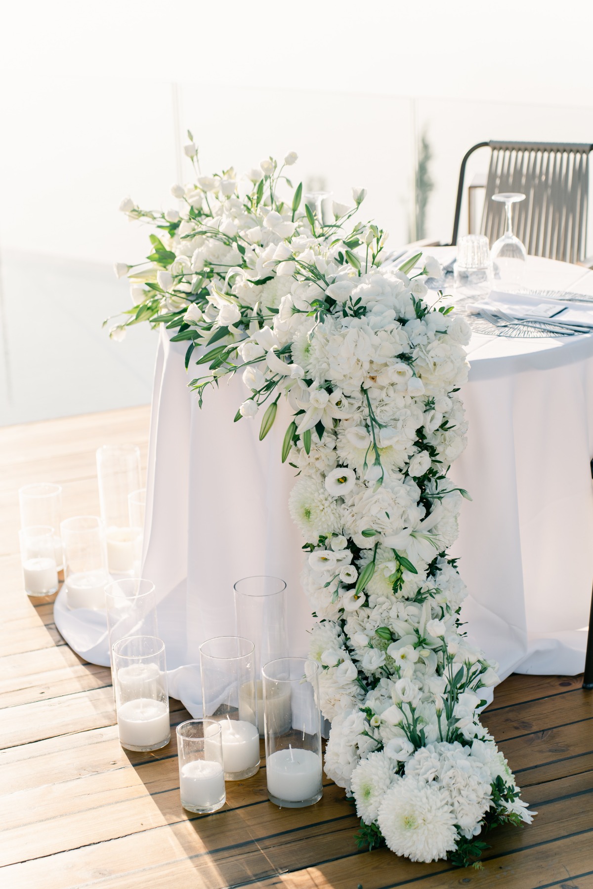 Romantic sweetheart table with luscious white floral garland