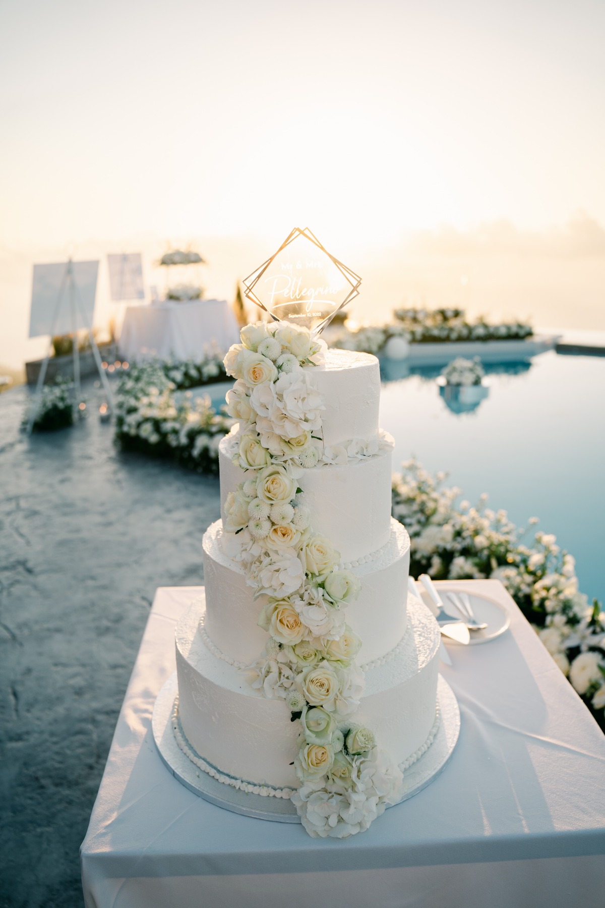 Luxurious four tier wedding cake in white with florals
