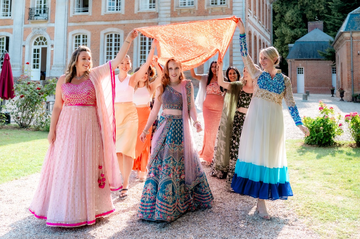 bride enters colorful multicultural indian wedding ceremony in france
