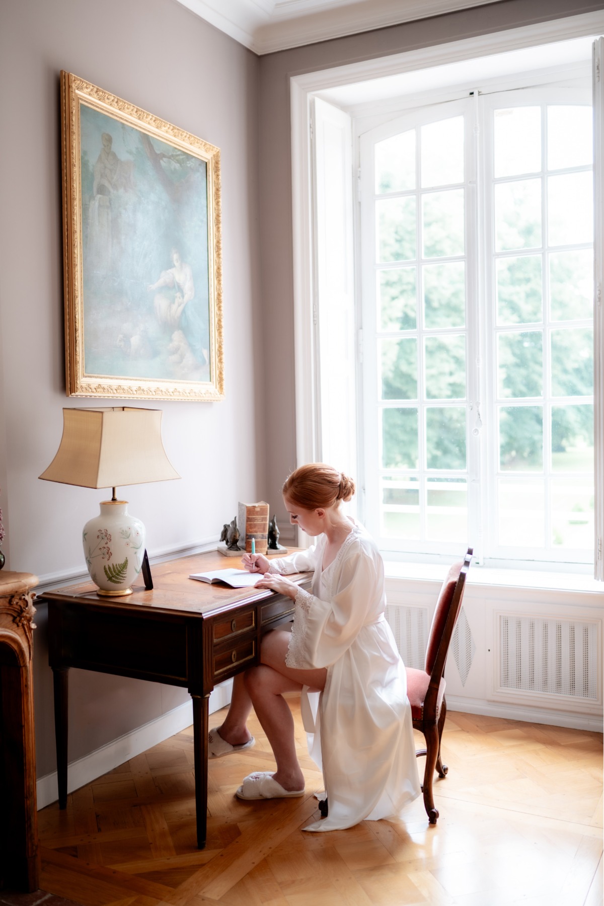 bride getting ready at a chateau in white robe