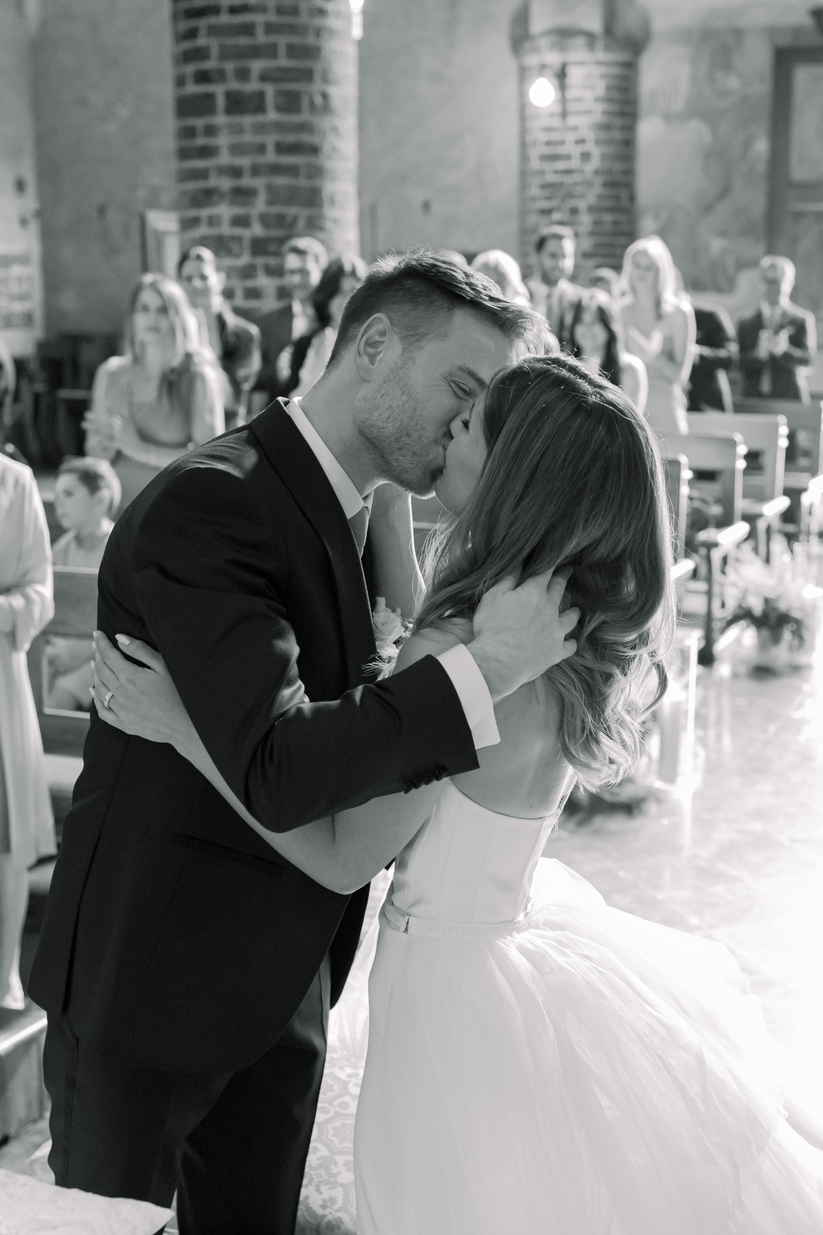 bride and groom kiss at chapel wedding