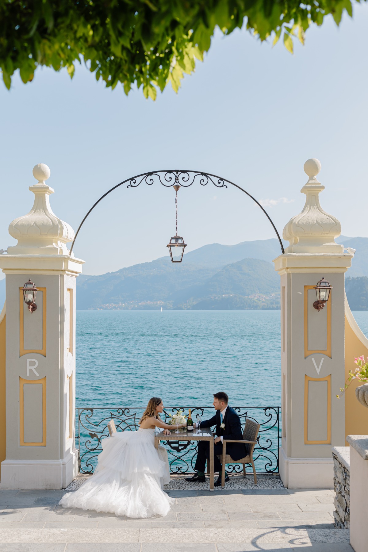 bride and groom toast at lake como