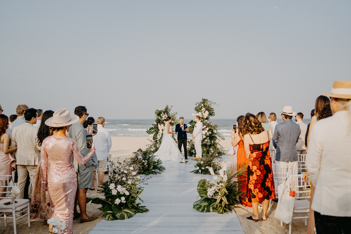 monstera leaf tropical floral arrangements at beach cermony