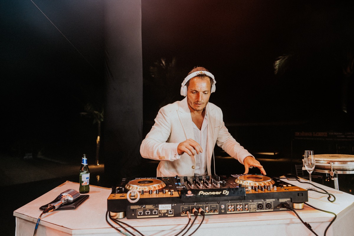 groom is a dj at music festival inspired wedding