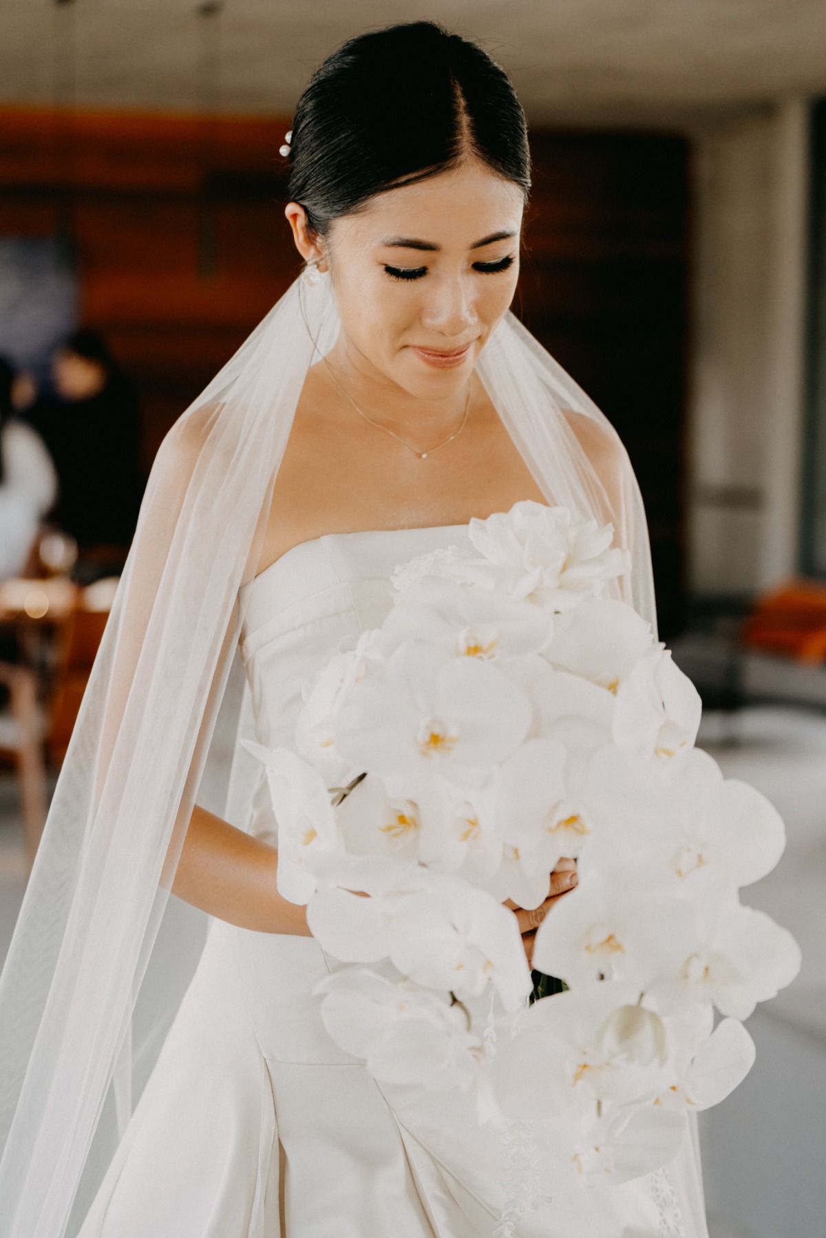 bride with orchid waterfall bouquet