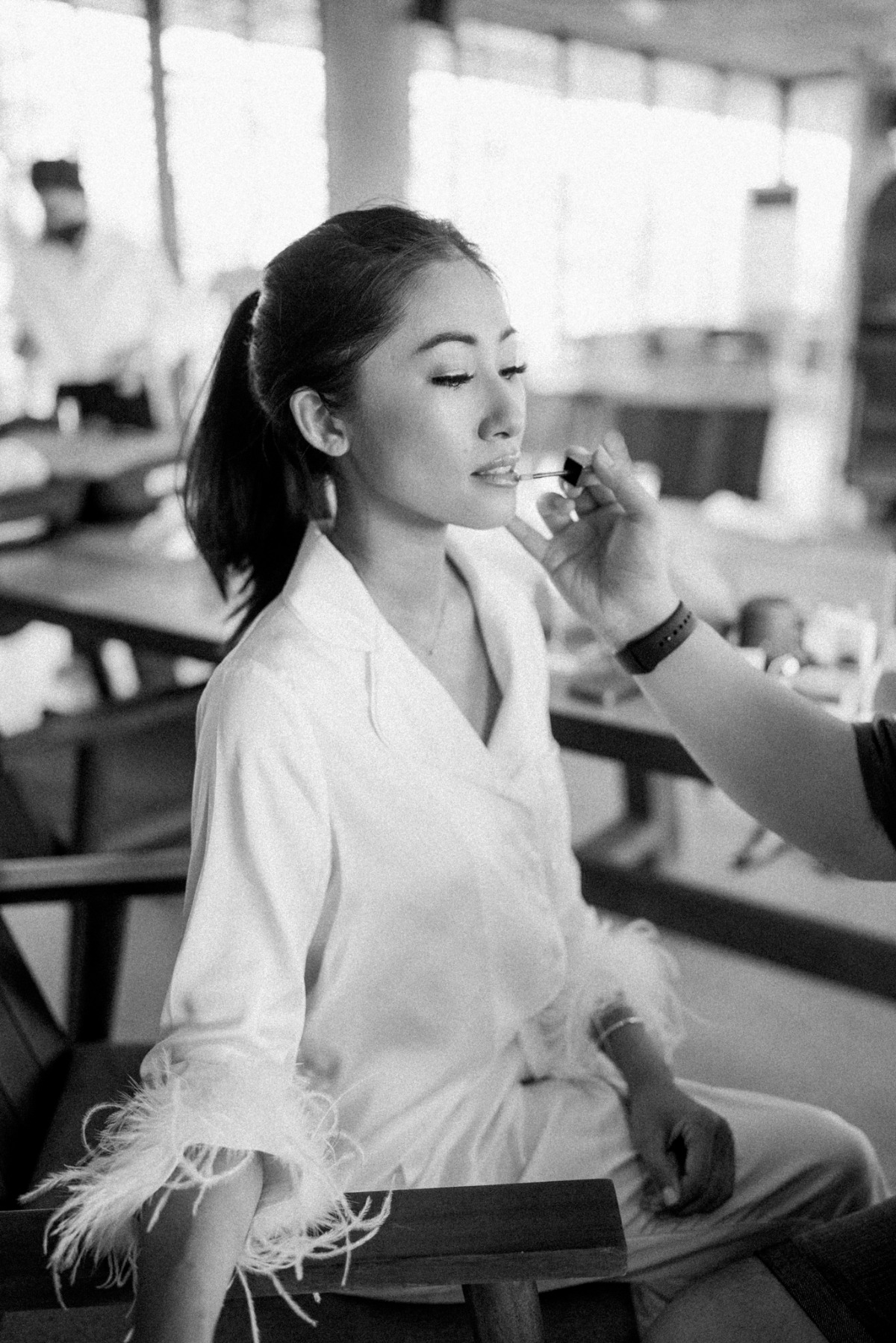 bride getting ready in feathered pajamas