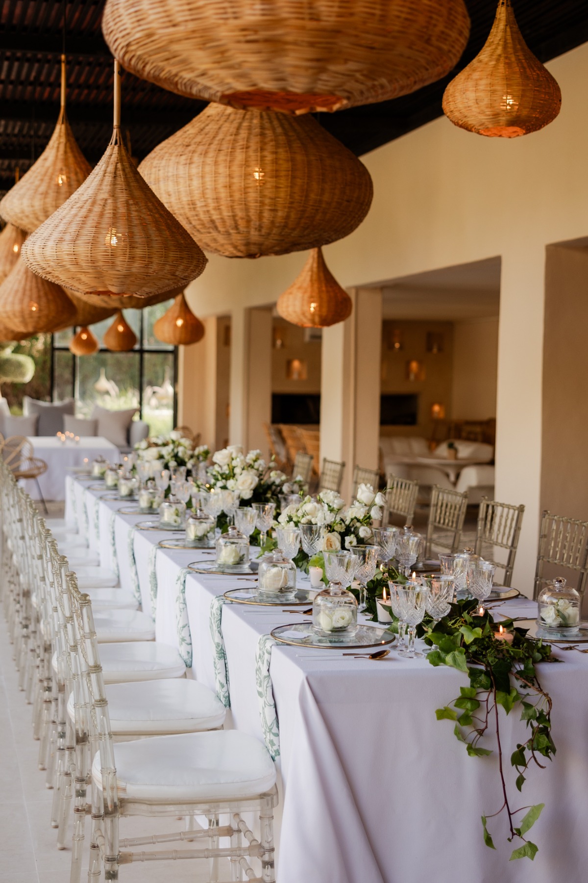 wicker lantern lighting and white florals at moroccan reception